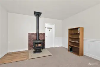 The new woodstove will keep the whole house warm.  This room can be used for so many things. Access to the laundry room is behind the door.