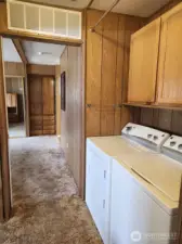 Just across the hall from the 2nd bedroom is the laundry alcove with lots of cabinet space above.