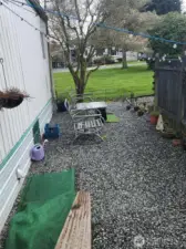 Off the deck, take the stairway down to the side yard with plenty of space for a seating area.