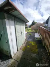 Behind the carport is a roomy shed for all your tools.