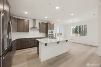 Gourmet kitchen overlooking island to dining