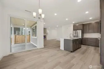 Dining room looking out at covered patio kitchen and great room