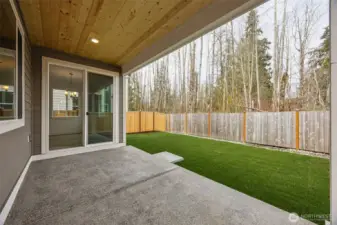 Covered patio looking out at backyard and protected space.