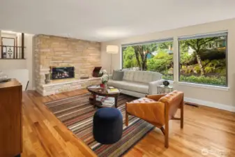 Large windows blend inside with the greenery of the front yard