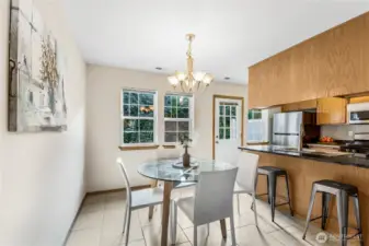 Dining room off of kitchen area with additional seating at counter.