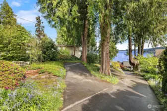 Driveway access with parking stalls for four cars.