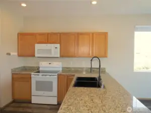THE CHEF WILL ENJOY PREPARING MEALS IN THIS GREAT KITCHEN WITH DOUBLE SINK AND NEWER APPLIANCES!