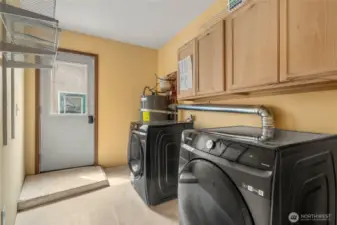 spacious utility room with side door access to detached garage