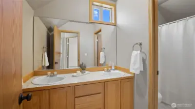 Upper floor main bathroom with double sinks.