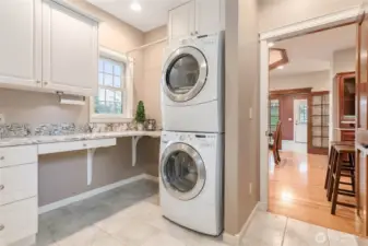 Large laundry room with extra storage between garage entrance and kitchen