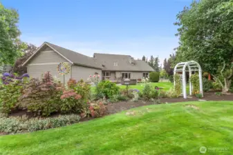 Mature landscaping beautifully frames this manicured property, creating a private and inviting setting.