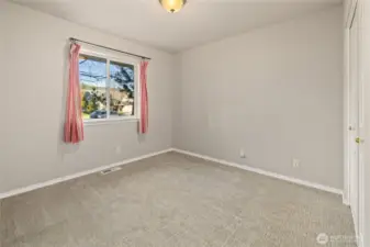 Extra Bedroom across from the Primary Bedroom. Has view of the front yard.
