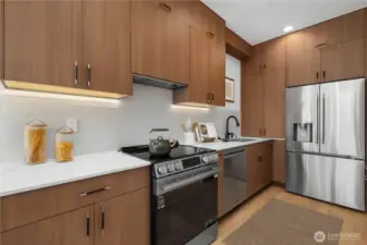 Sleek PNW crafted cabinetry with under cabinet lighting + appliance garage