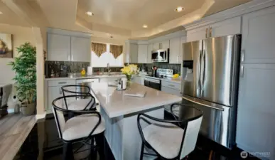 Remodeled kitchen with eating island and quartz countertop