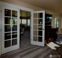 Charming French doors leads you into a spacious  bedroom in penthouse with 2 balconies and stunning views from this top floor