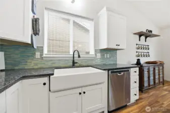 Farmhouse sink, granite counters and high-end cabinets with crown molding