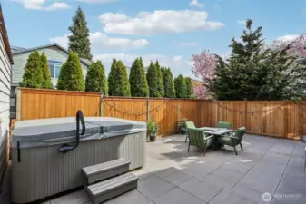 Private fully fenced back yard with hot tub.