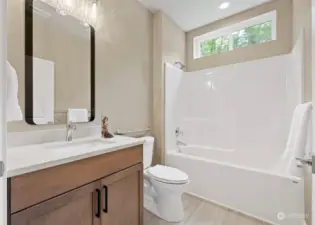 Kohler comfort-height toilets are featured in both baths.