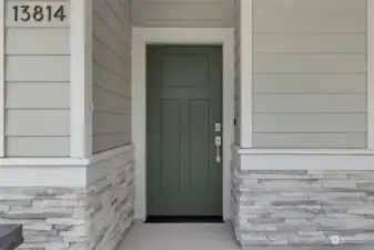 Tasteful stonework highlights the recessed entry...with no steps from drive to entry or garage.