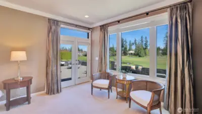 Primary suite enjoys access to the expansive patio and golf course views