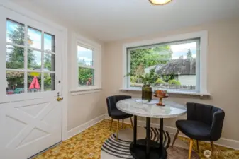 The Kitchen Nook is bright and airy with windows on three sides and a Dutch door that opens to the Trex deck and backyard beyond.