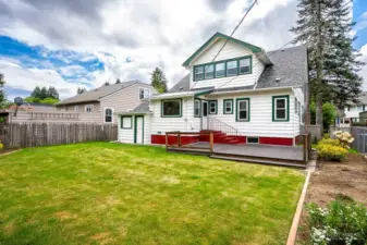 The backyard is fully fenced and features an expansive Trex deck off the Kitchen Nook, a generous lawn, garden space and mature, blooming shrubbery!