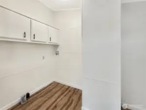 Functional laundry room with exterior access and space for added storage or shelving.