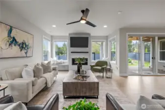 Open-concept living room with built-in bench and beautiful windows.