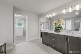 Dual vanities and access to a custom walk-in closet.