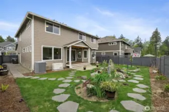 Beautiful backyard with custom water feature and pathways. Standby automatic generator (Generac) – keeps the home powered during outages