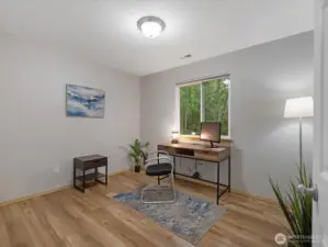 Bed 3 staged as office w/ view of green belt