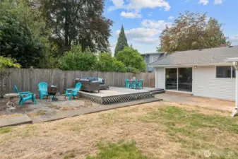 BIG yard with deck & fire pit area.
