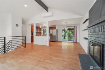 Living room with vaulted ceiling and fireplace