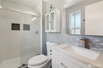 Primary bath with tile shower and bidet toilet.