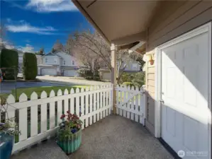 Picket-fence dreams with your private front porch area and  door leading to the 2-car garage
