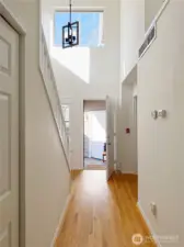 Grand sunny entry with beautiful wood floors.