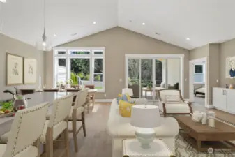 Great room with vaulted ceiling, engineered plank flooring and wide millwork throughout. This home is virtually staged.