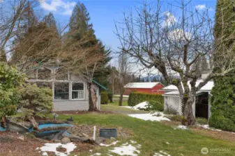 View of the West side of the home with what used to be a koi pond and the outbuilding