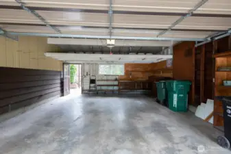 Huge garage with space for a shop/workbench.