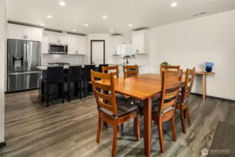 Open concept dining room flowing into kitchen.