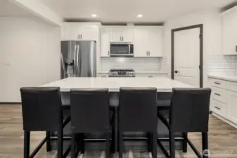 Large kitchen with ample counter space & cabinet storage.