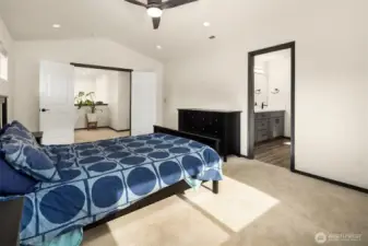 Primary bedroom with french doors and ensuite bathroom.