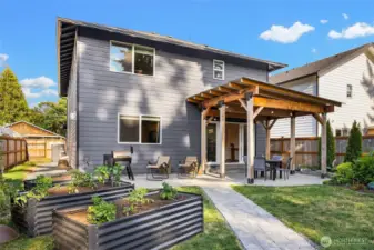 Serene garden space & covered patio in backyard.