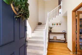 As you enter the home, you have tall ceiling and stairs leading to 3 bedrooms upstairs
