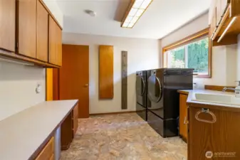 sink, storage give plenty of space for laundry and landing room from the 2 car garage