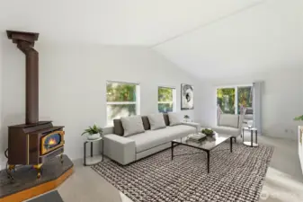 The family room is a true heart-of-the-home space, highlighted by a charming corner fireplace and a slider that opens to the expansive back deck and yard.