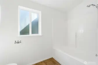 The bathroom features a full tub/shower combo and feels brand-new with fresh paint and updated flooring.