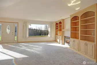 Custom built-in book shelves surround the gas fireplace in the living room.