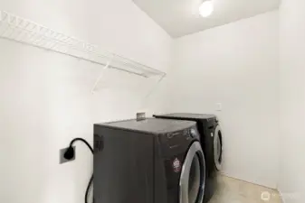 Large laundry room with room for storage.