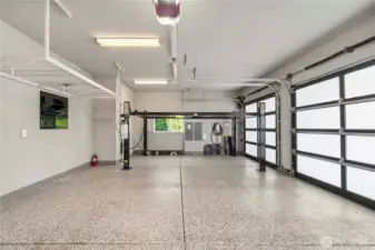 Spacious 3-car garage equipped with an auto lift and Tesla charger
